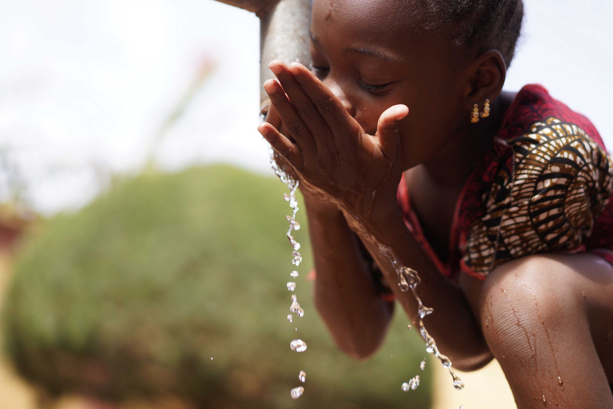 1597203496 Human Rights and Climate Change Symbol: African Black Ethnicity Girl Woman Drinking Safe Water